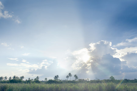 Blue sky & clouds with sun rays, bright & shining, Good for travel or wanderlust background.の写真素材