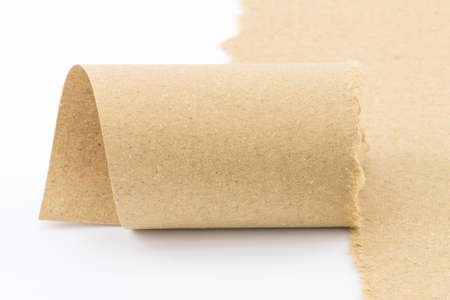 Blank brown paper roll, good for conceptual words background, web page, graphic design, catalog or texture. Isolated on white.の写真素材