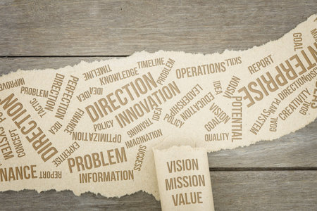 Business conceptual words with brown paper sheets or notes stick on a wooden background. Attached...