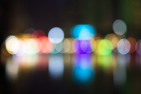 Abstract city street light defocused at night, blur bokeh, colorful & dark background.