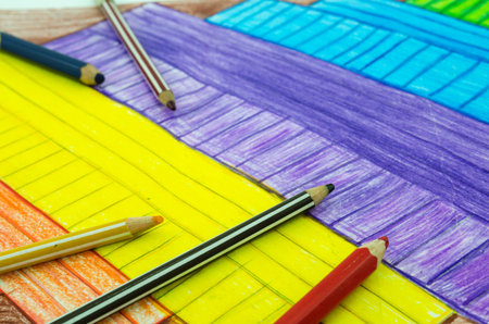 Simple children drawing with color pencil laying, colorful background. Back to school.