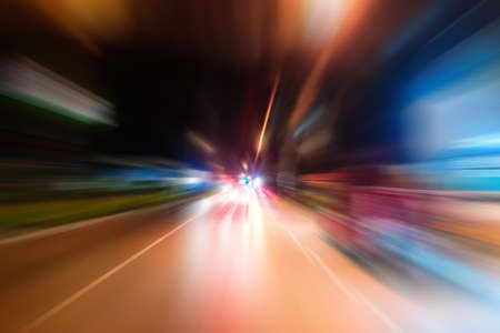 Night traffic with futuristic motion blur and zoom effects. On the road or streets, shoot from inside a moving car.の写真素材