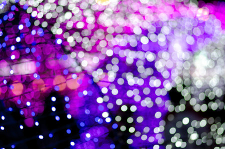 Abstract colorful blur bokeh fairy light festival, city street light defocused at night, dark...