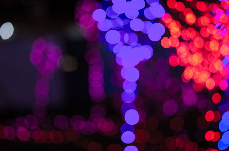 Abstract colorful blur bokeh fairy light festival, city street light defocused at night, dark...