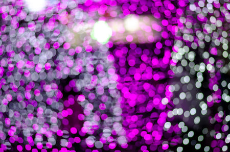 Abstract colorful blur bokeh fairy light festival, city street light defocused at night, dark...