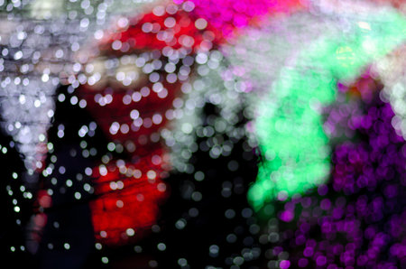 Abstract colorful blur bokeh fairy light festival, city street light defocused at night, dark background.の写真素材