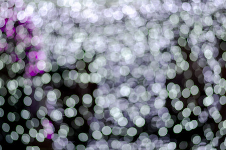 Abstract colorful blur bokeh fairy light festival, city street light defocused at night, dark...