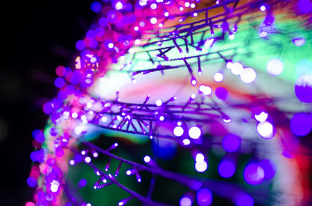 Abstract colorful blur bokeh fairy light festival, city street light defocused at night, dark...