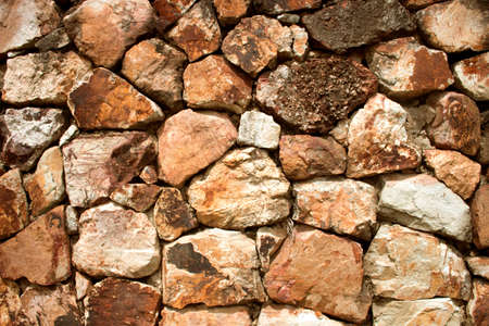 Fragment of a wall from a chipped stone backgroundsの写真素材