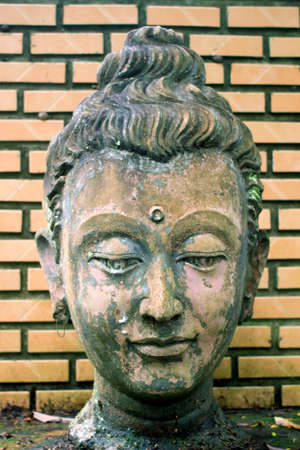 close-up 400 years old of ancient head stone buddha statue at historical museum Thailandの写真素材