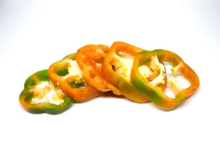 Sliced red yellow green pepper isolated on white backgroundの写真素材