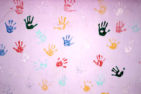 Multiple colored hand prints on  backgroundの写真素材