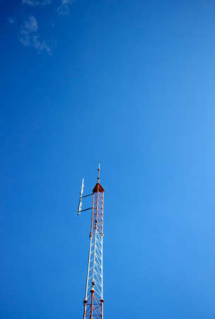 Telecommunication tower on blue sky blank backgroundの写真素材