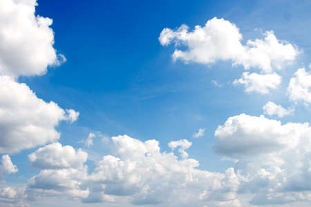 Blue sky background with white cloudsの写真素材