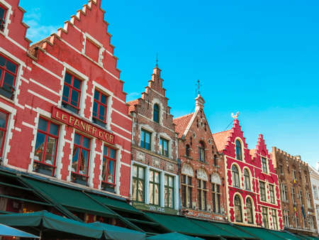 Bruges, Belgium. Colorful historic buildings at Market Square in with clear skies.のeditorial素材