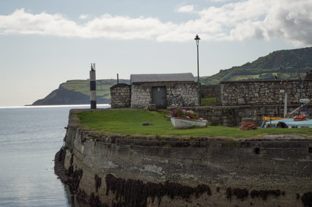 A harbor in Northern Ireland filled with boats, looking out to sea.