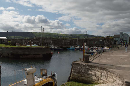 A harbor in Northern Ireland filled with boats, looking out to sea.の写真素材