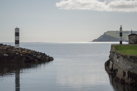 A harbor in Northern Ireland filled with boats, looking out to sea.