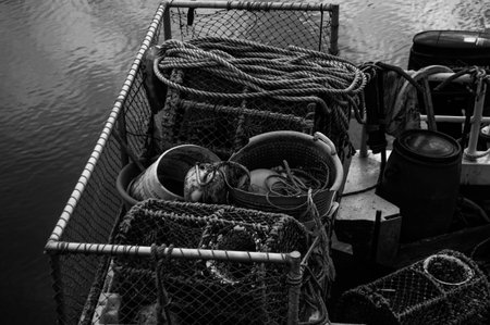 A close up of a fishing boat, filled with nets, rope and line in a messy layout, about to set out to...
