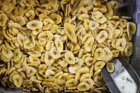 Sliced dried bananas with a metal shuffel spoonの写真素材