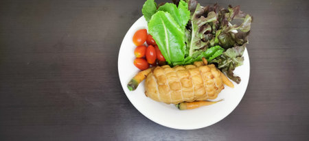 Chicken Breast Salad healthy food arranged in a white plate on black wooden floorの写真素材