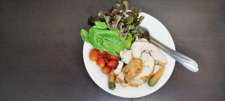Chicken Breast Salad healthy food arranged in a white plate on black wooden floorの写真素材