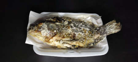 Grilled tilapia with salt, a healthy food, commonly eaten as an evening meal. Eat with fresh vegetables / eat with hot steamed riceの写真素材