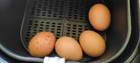 Boiled chicken eggs in an oil-free fryer are hot and ready to eat. from top viewの写真素材