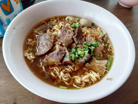 Mama, meatballs, tenderloin, in a white bowl, garnished with coriander, fragrant, appetizing, placed on a wooden tableの写真素材