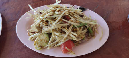 Thai papaya salad. Sweet and sour taste than salty. Northeastern food. Popular menu of Thailand. Served on the table from top viewの写真素材