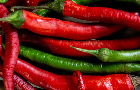 Spicy green and red peppersの写真素材