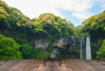 Blurred Cheonjiyeon Waterfall is a waterfall on Jeju Island, South Korea with wooden bridge.の写真素材