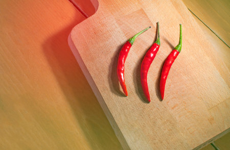 Still life Red Thai Chili on wooden background. Bright tone.