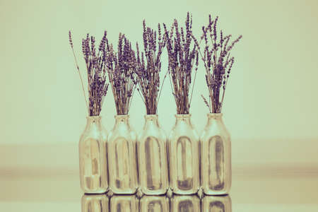 Still life Blossom Lavender in luxury bottle with clear white wall.の写真素材