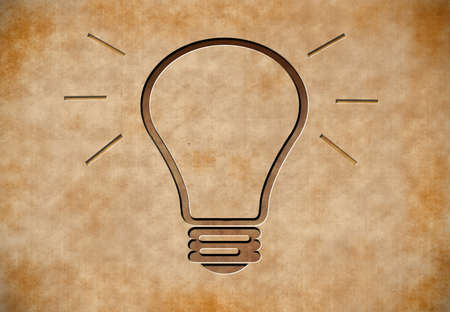 Carved light bulb on Vintage Old Paper Templateの写真素材