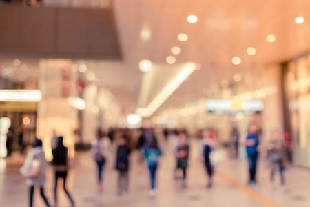Blurred tourists in shopping mall with bokeh - retro colorの写真素材