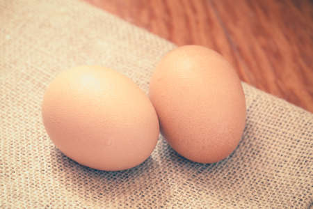 Fresh eggs on a wooden background. Vintage tone.の写真素材