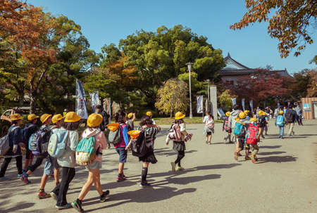 OSAKA,JAPAN, MARCH 12, 2015: Japanese young elementary students are having field trip in Osaka Castle, Japan.のeditorial素材