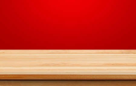Empty wooden table with red christmas background for product placement with blur christmas wallpaper backgroundの写真素材