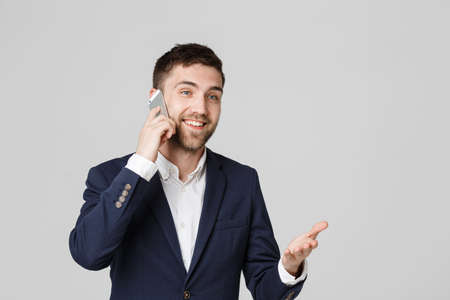 Lifestyle and Business Concept - Portrait of a handsome businessman enjoy talking with mobile phone. Isolated White background. Copy Space.の写真素材