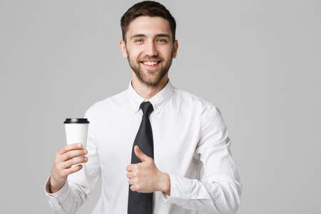 Portrait of a handsome businessman in formal suit with a cup of coffee.の写真素材