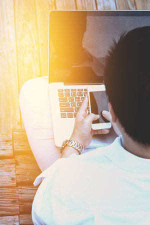 Close-up smart Business man wearing modern black suit and white shirt and texting on mobile smart...