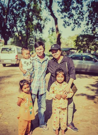 CAMBODIA - FEBUARY 18,2017 : Unidentified Asian tourist holding and playing with poverty children in...
