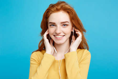 Lifestyle concept - Portrait of cheerful happy ginger red hair girl enjoy listening to music with...
