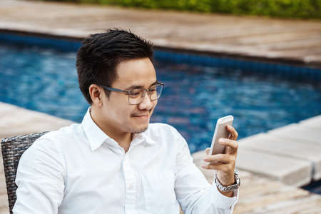 Young Handsome man enjoy shopping online on mobile phone with credit cardの写真素材