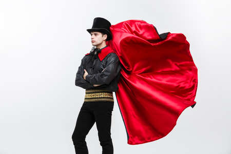 Vampire Halloween Concept - Portrait of handsome caucasian Vampire halloween costume fluttering his red, black cloak.の写真素材