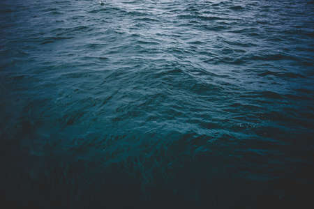 Blue sea surface, top view. Dark mood toneの写真素材