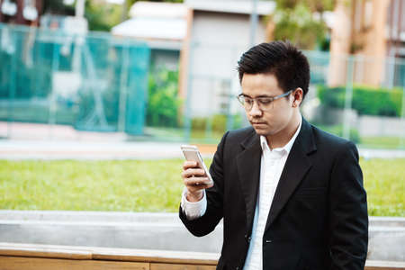 Concept Business - Business man serious with his project on his mobile phoneの写真素材
