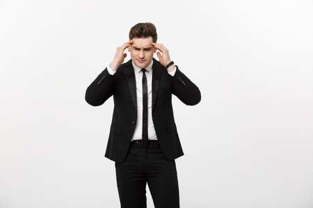 Business Concept: Young handsome businessman with pain in his temples. Photo of man suffering from...