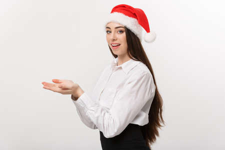 Business Concept - Modern caucasian business woman in the white studio background holding hand onside presenting product.の写真素材